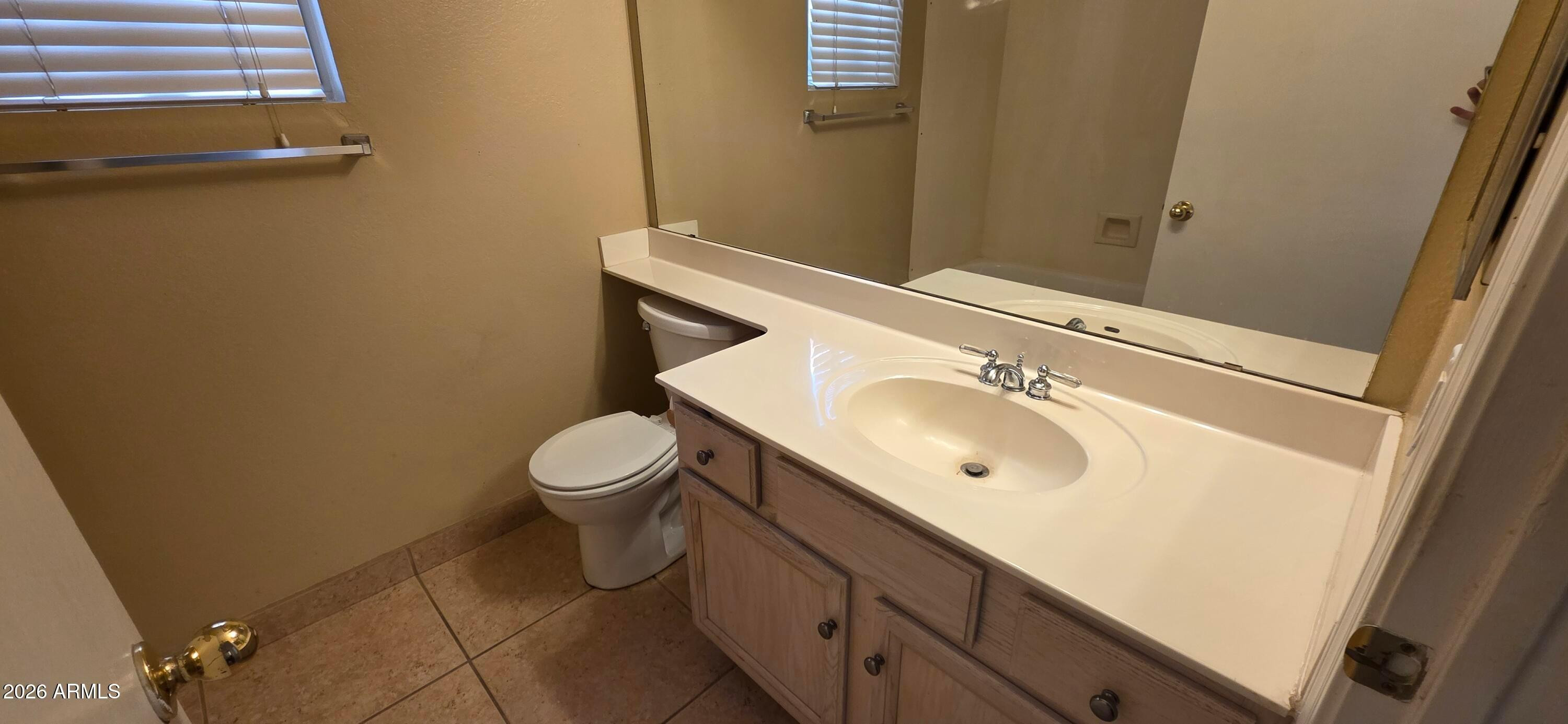 9163 West Davis Road Peoria, AZ 85382 - Photo 13 of 24 a bathroom with a sink a toilet and mirror