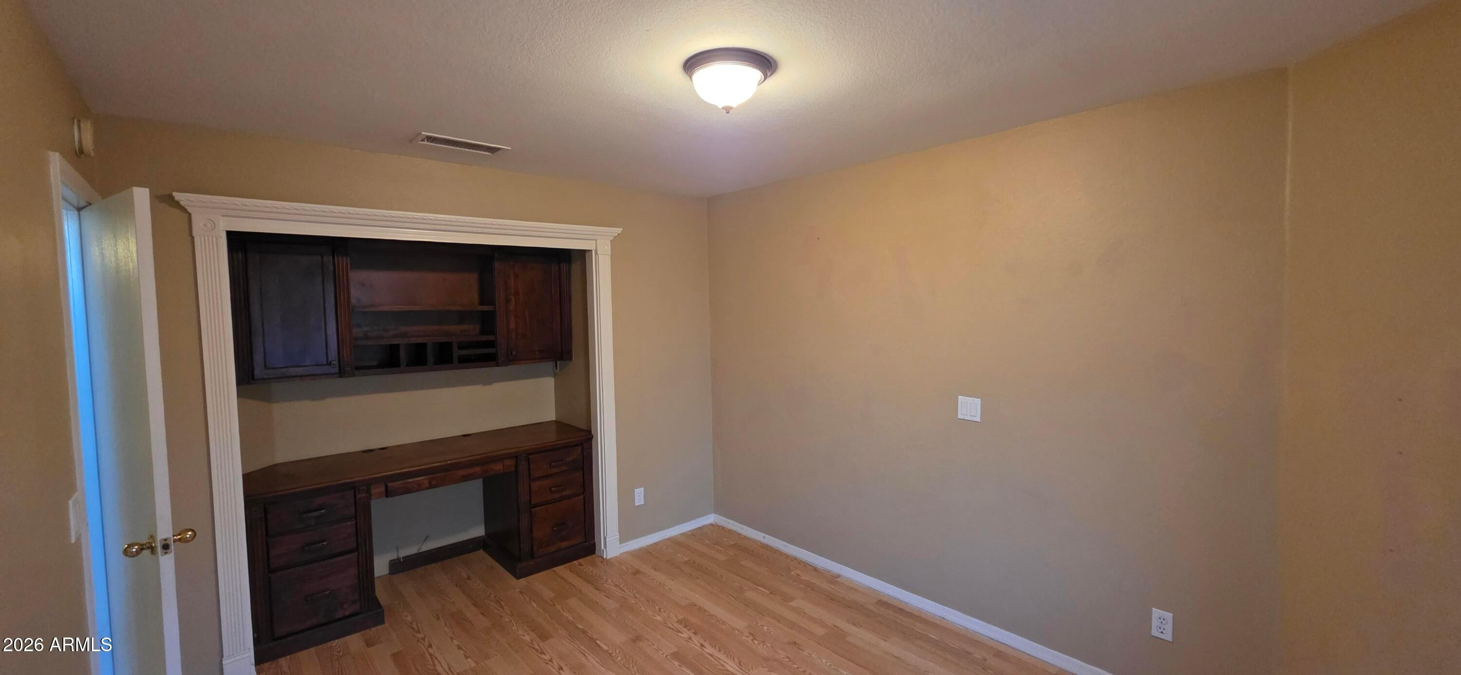 9163 West Davis Road Peoria, AZ 85382 - Photo 18 of 24 a room that has a bed and a television in it