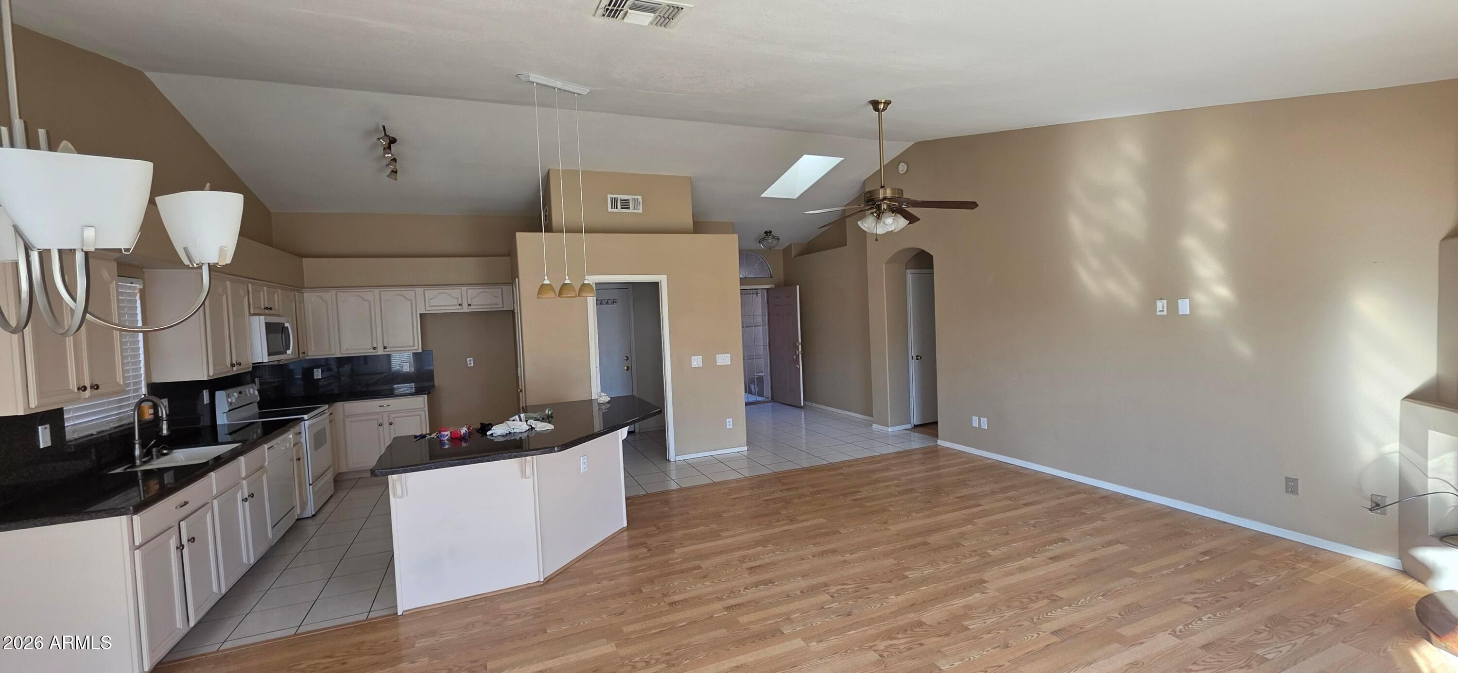 9163 West Davis Road Peoria, AZ 85382 - Photo 8 of 24 a large kitchen with cabinets and wooden floor