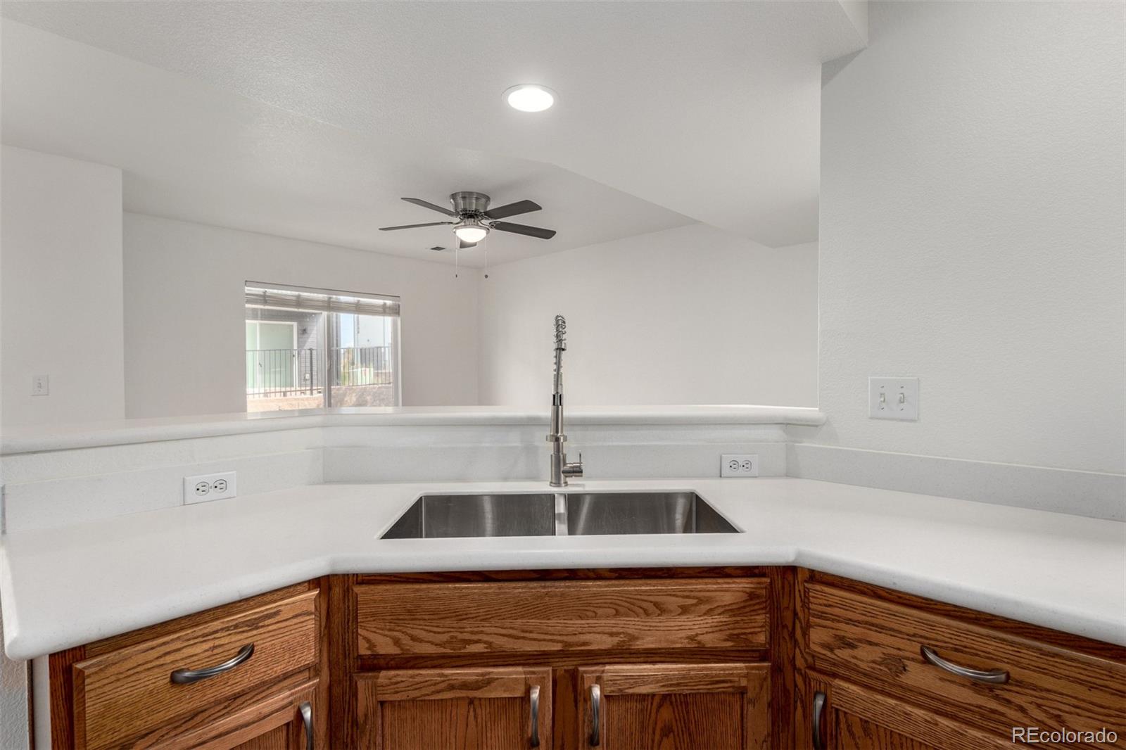 5850 Ceylon Street, Unit D Denver, CO 80249 - Photo 11 of 33 a kitchen with a sink cabinets and window