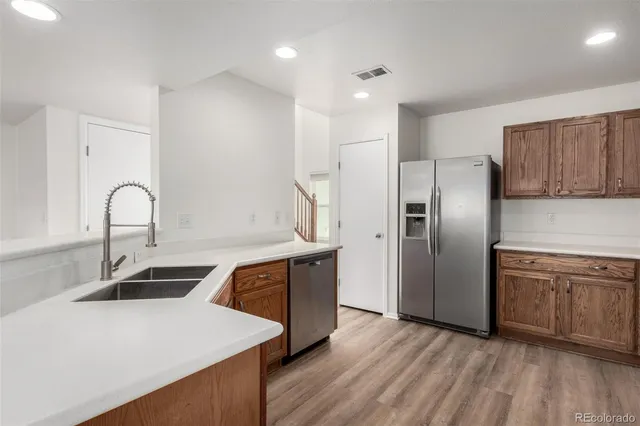 a kitchen with stainless steel appliances a sink and a refrigerator