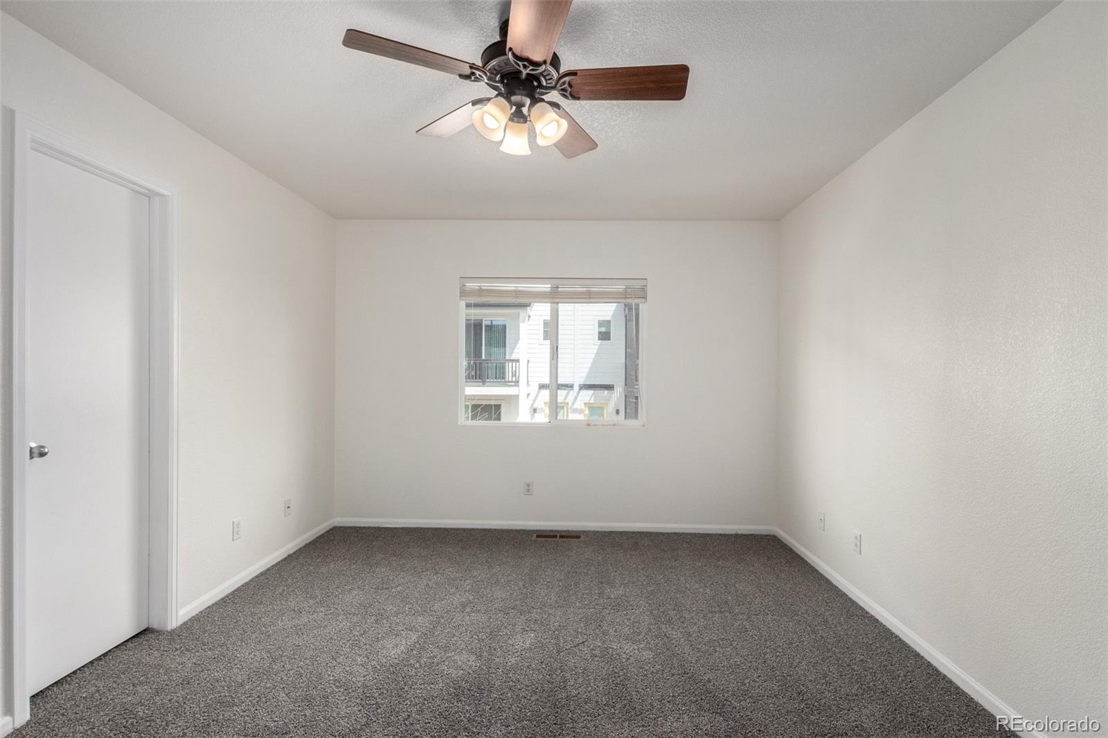 5850 Ceylon Street, Unit D Denver, CO 80249 - Photo 15 of 33 an empty room with a window and a fan