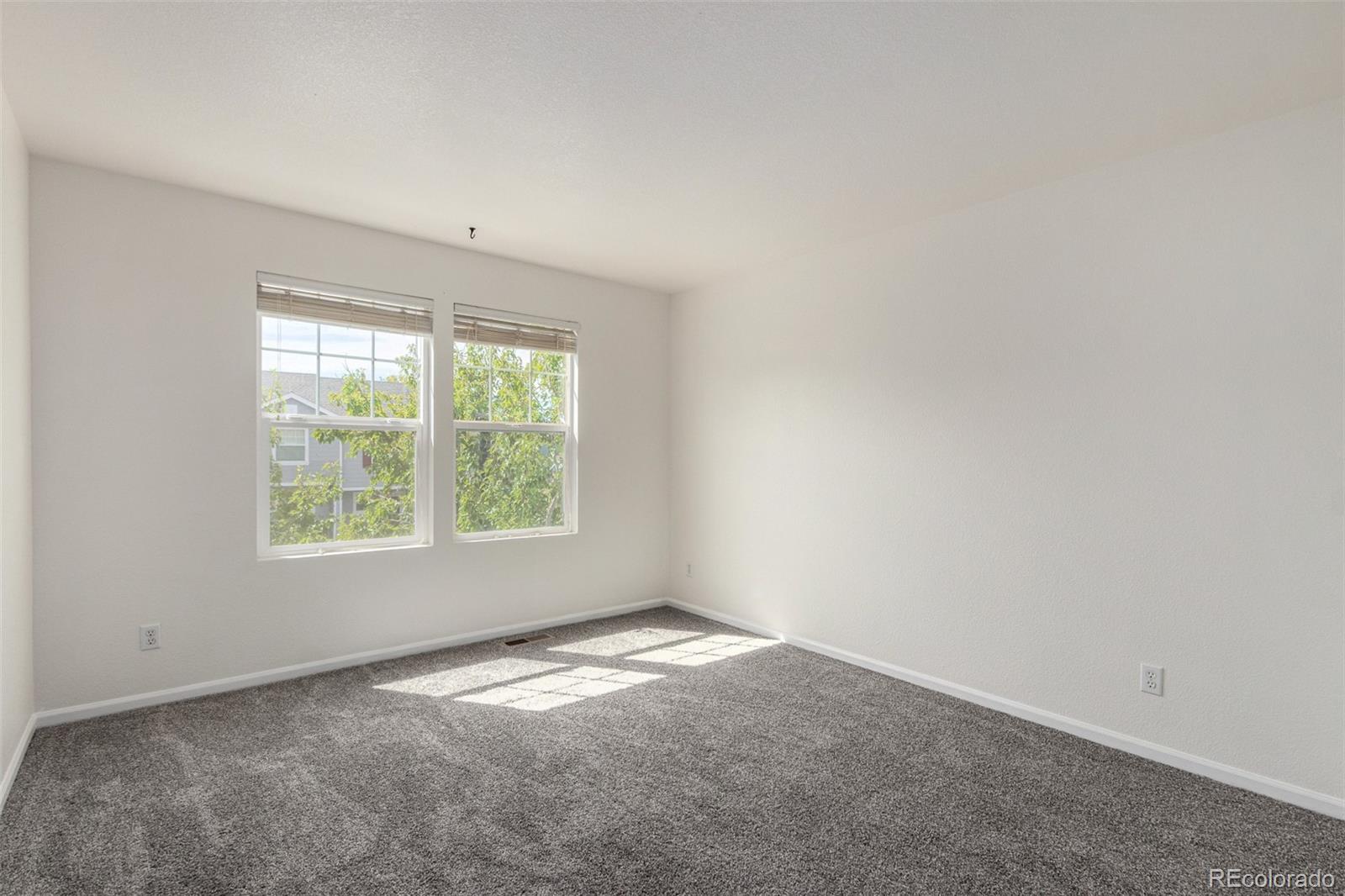 5850 Ceylon Street, Unit D Denver, CO 80249 - Photo 20 of 33 an empty room with a window