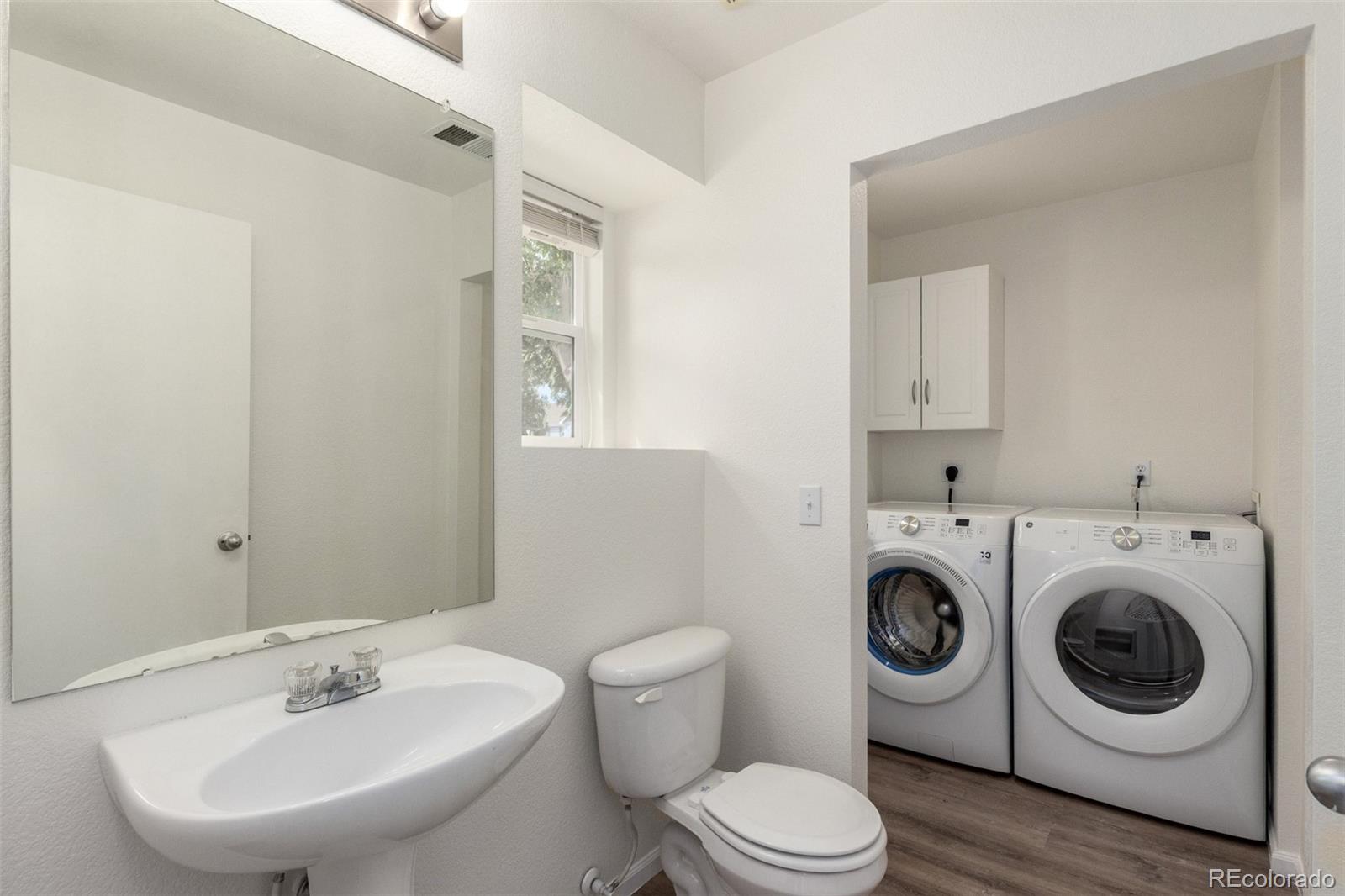 5850 Ceylon Street, Unit D Denver, CO 80249 - Photo 22 of 33 a white toilet sitting next to a bathroom sink