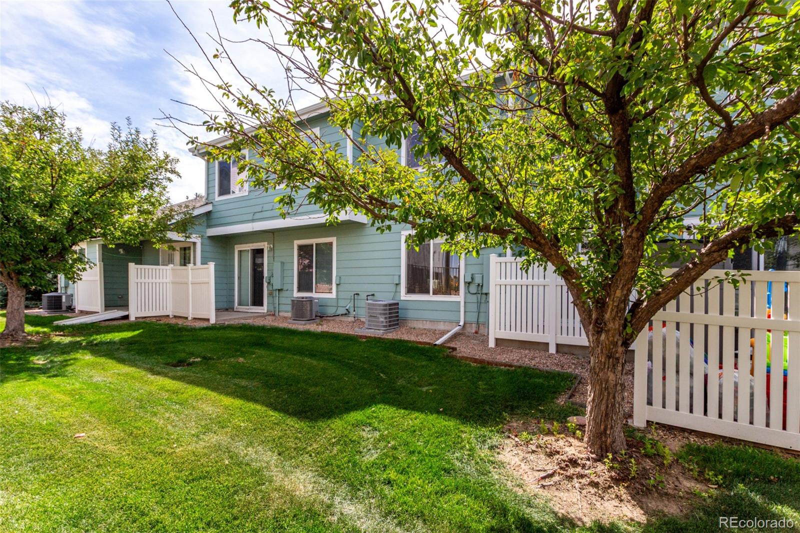 5850 Ceylon Street, Unit D Denver, CO 80249 - Photo 27 of 33 a front view of a house with a yard and trees