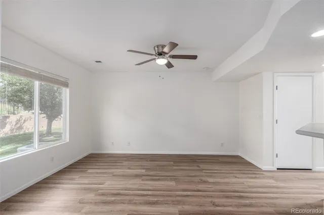 wooden floor in an empty room with a window