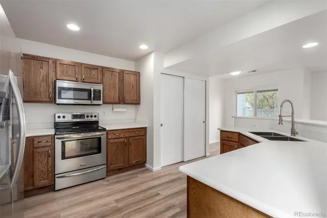 a kitchen with sink a microwave and refrigerator