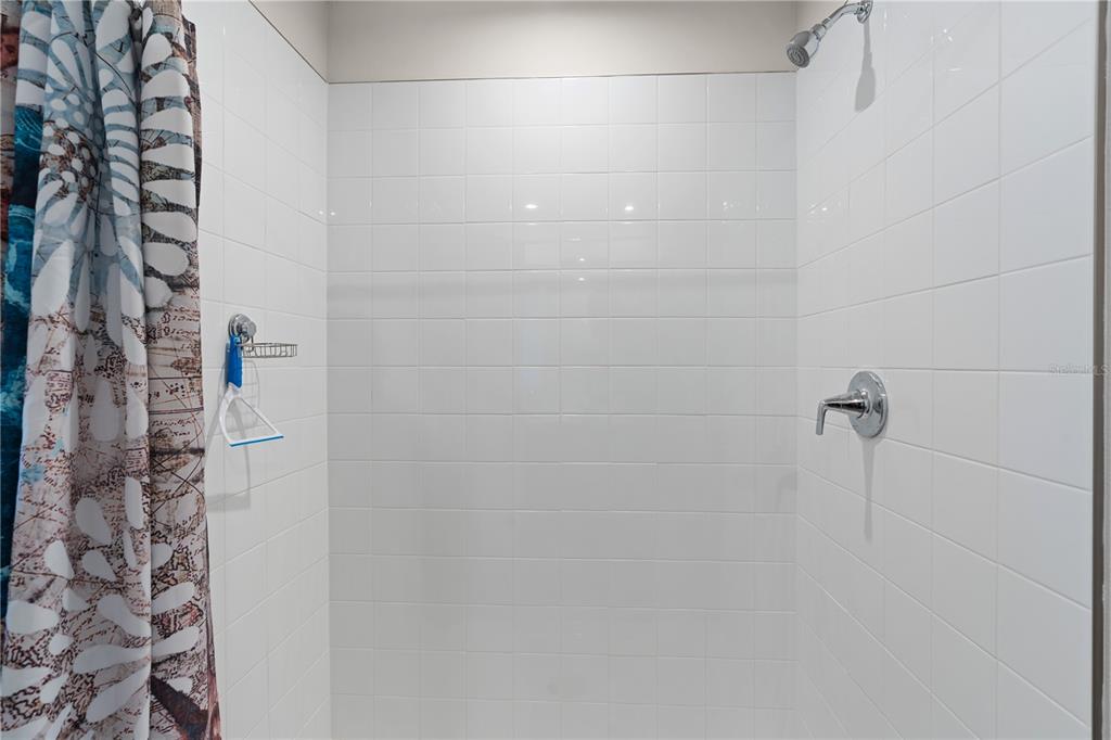 12003 Grizzly Lane New Port Richey, FL 34654 - Photo 30 of 43 a bathroom with a shower