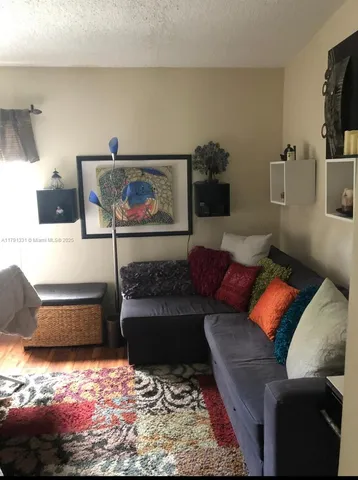 a living room with furniture and a rug