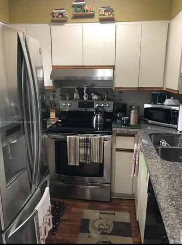 a kitchen with a stove and a refrigerator