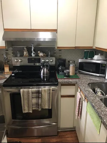 a kitchen with a stove and a refrigerator