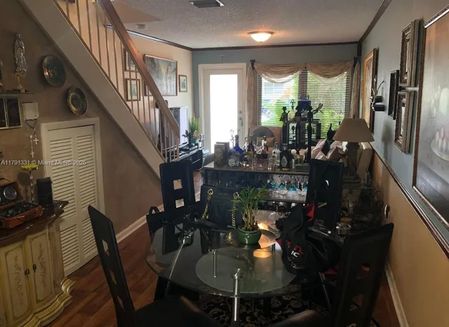 a dining room with furniture and a chandelier
