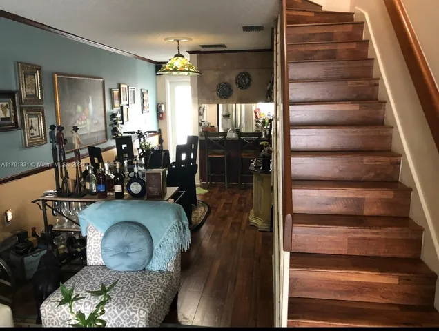 a dining room with furniture and wooden floor