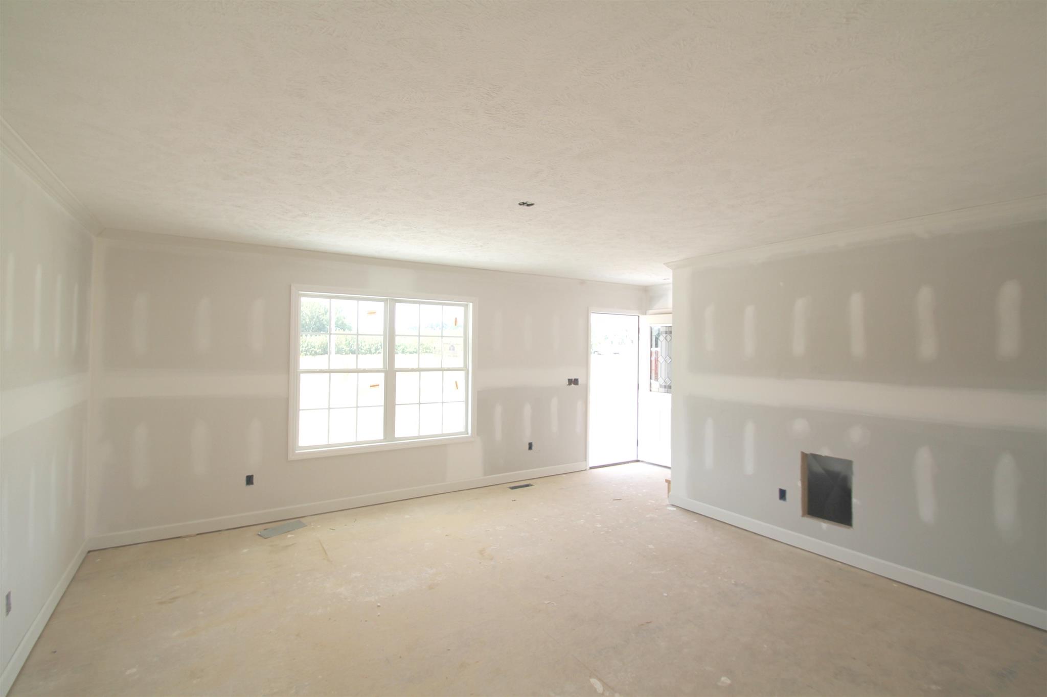 194 Ferrells Loop Road Manchester, TN 37355 - Photo 2 of 10 an empty room with windows and fireplace
