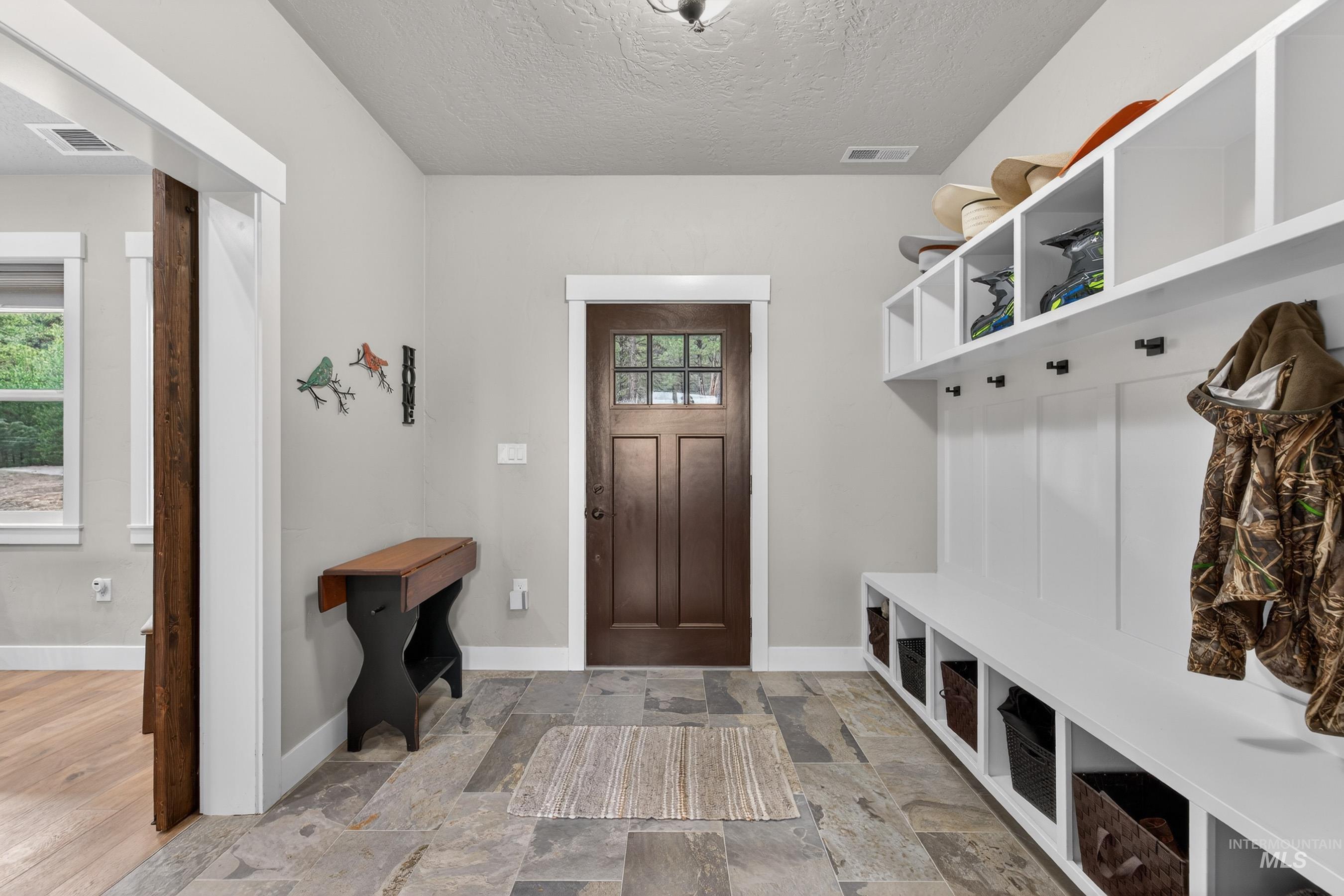 10191 Timberrim Drive Cascade, ID 83611 - Photo 11 of 44 Mudroom with a textured ceiling and light stone finish flooring