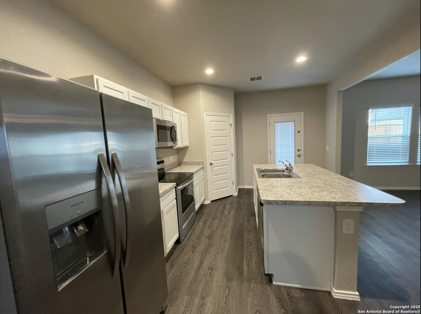 13018 Candace Way St. Hedwig, TX 78152 - Photo 3 of 15 a kitchen with kitchen island a counter top space cabinets and stainless steel appliances