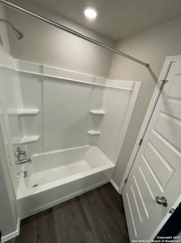 a bathroom with a bathtub and a shower