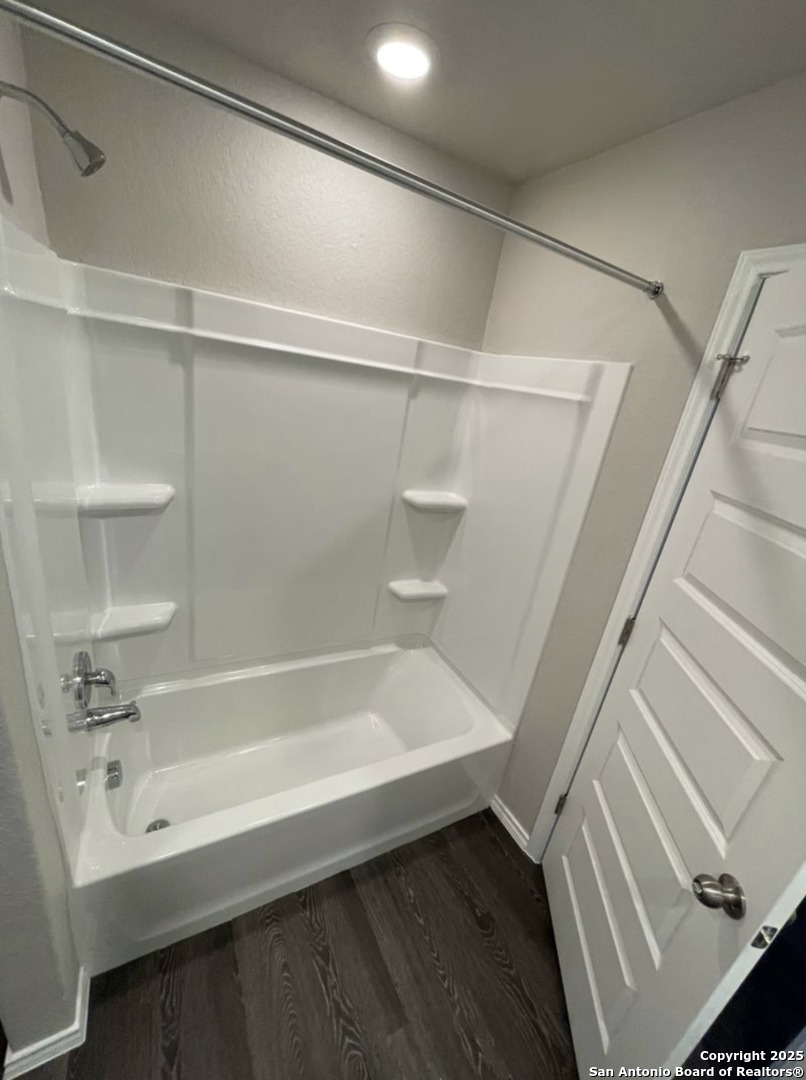 13018 Candace Way St. Hedwig, TX 78152 - Photo 6 of 15 a bathroom with a bathtub and a shower