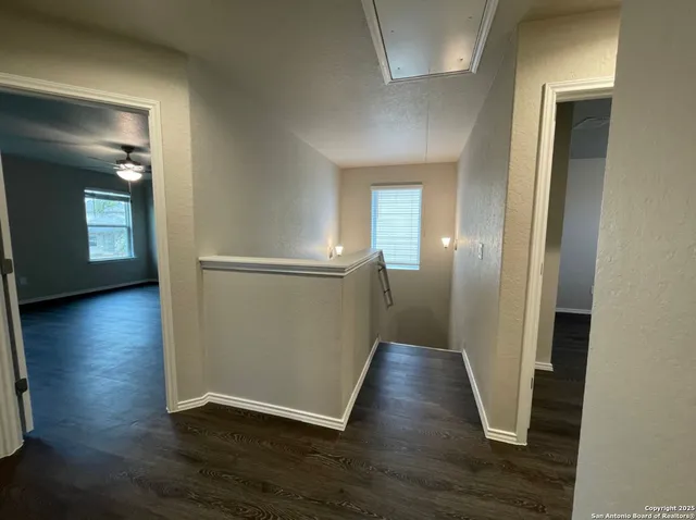 a view of a hallway with wooden floor