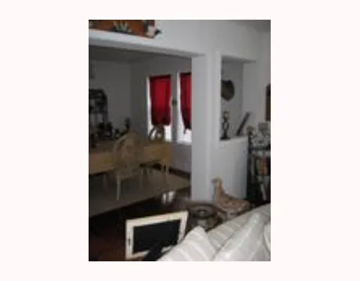 a kitchen view with wooden floor and furniture