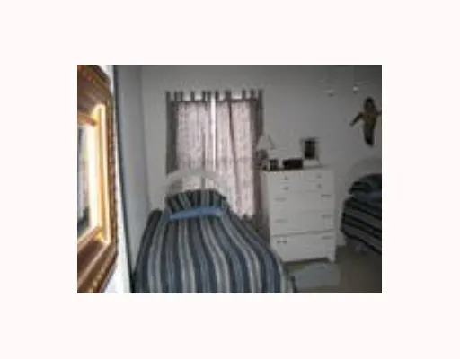a bathroom with a granite countertop sink a mirror and a bathtub