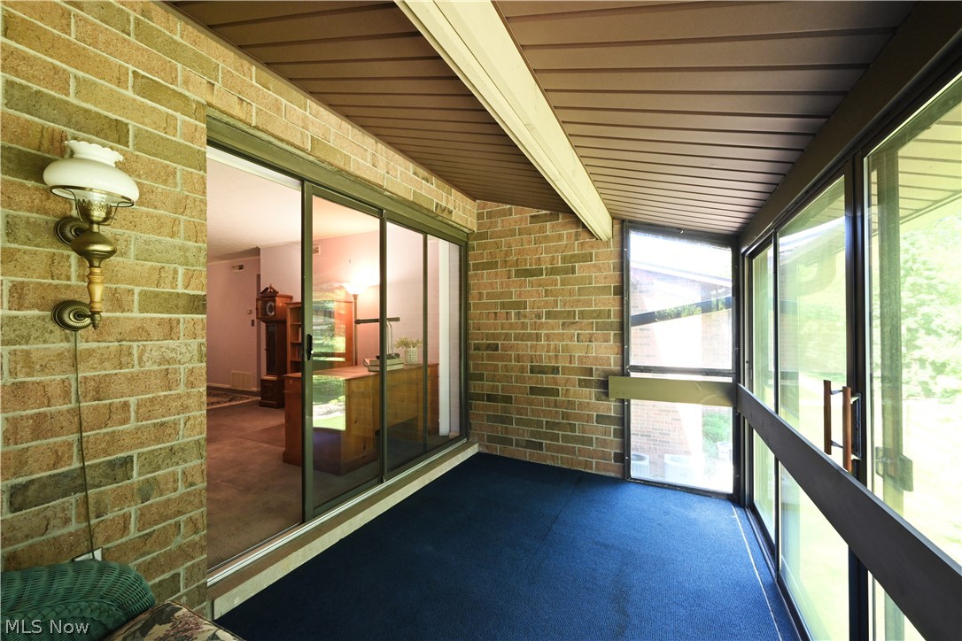 22962 Maple Ridge Road, Unit 206 North Olmsted, OH 44070 - Photo 24 of 33 Unfurnished sunroom featuring beamed ceiling