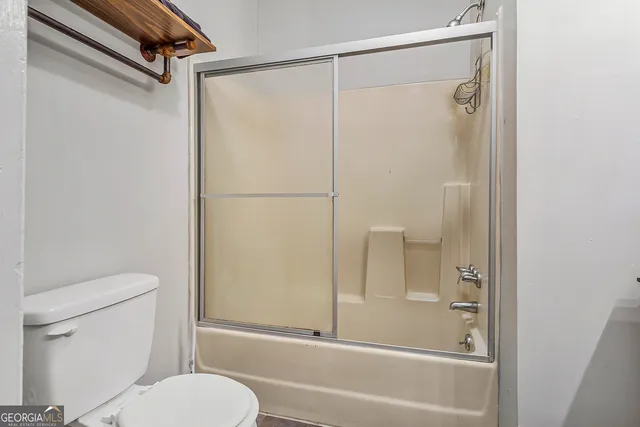 a view of a livingroom with wooden floor and furniture