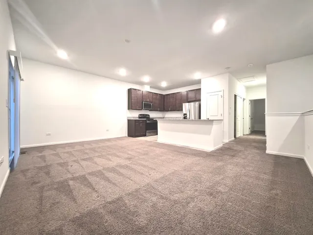 a view of a kitchen with a sink and a refrigerator