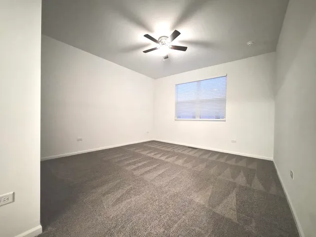 an empty room with closet and windows