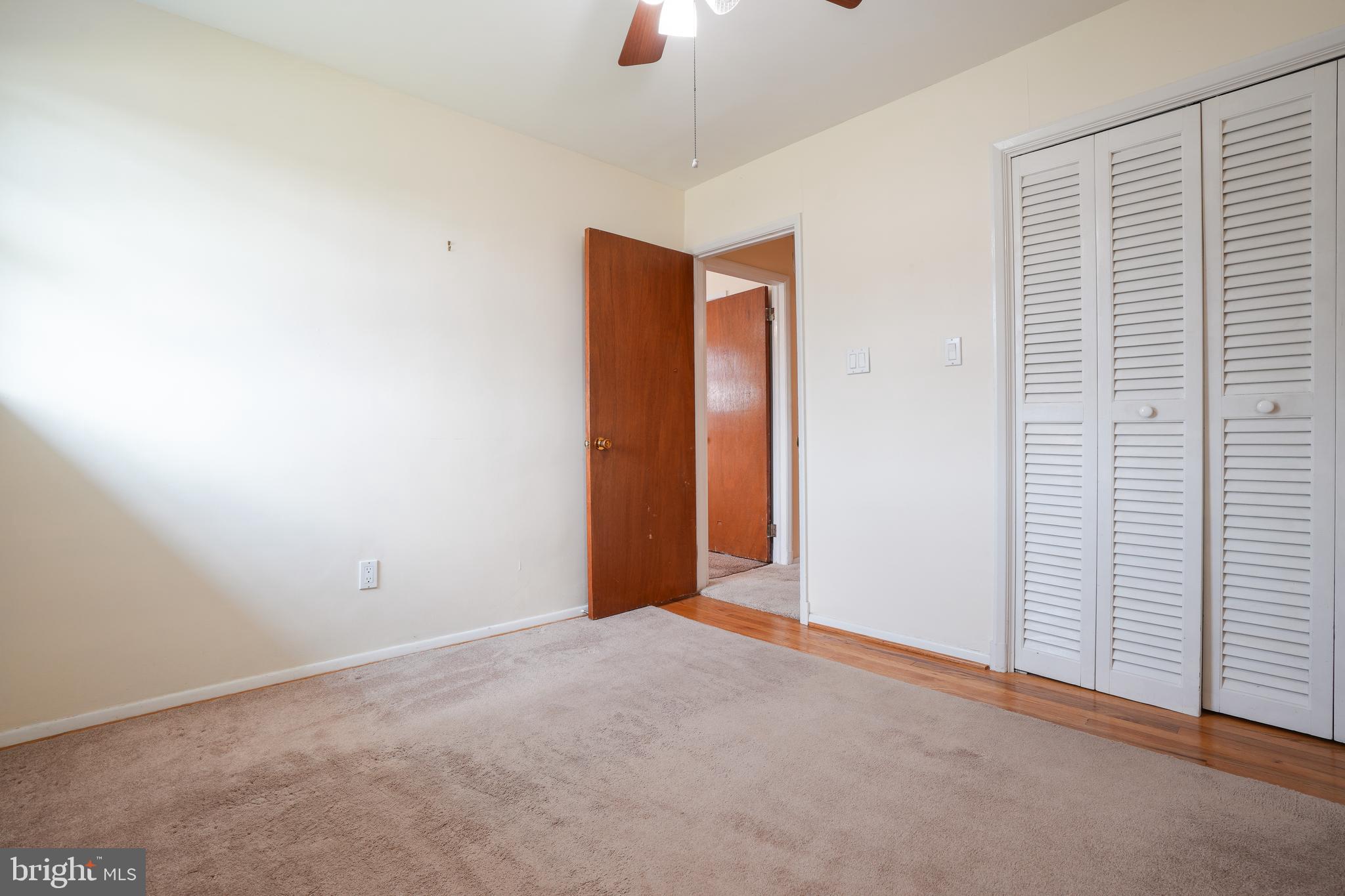 437 Neepier Road Baltimore, MD 21228 - Photo 18 of 29 Bedroom #2 with wood floor under area rug