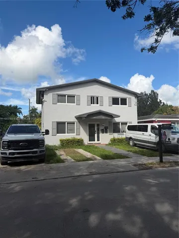 a view of house with outdoor space and car parked