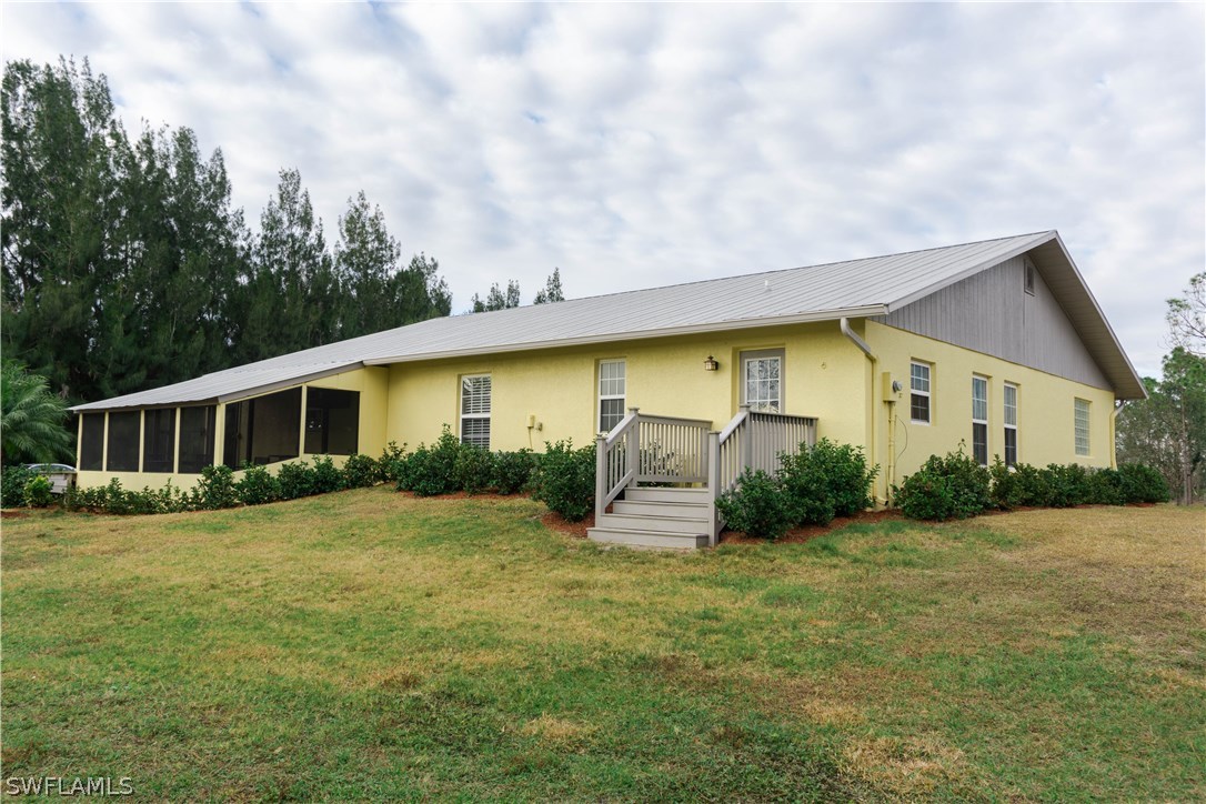 10280 Deal Road North Fort Myers, FL 33917 - Photo 7 of 25 a front view of house with yard and green space
