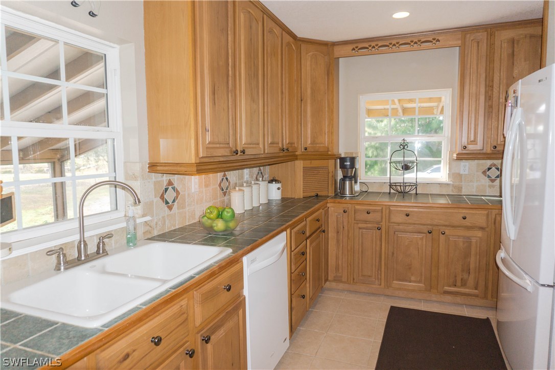 10280 Deal Road North Fort Myers, FL 33917 - Photo 9 of 25 a kitchen with a sink stove and cabinets
