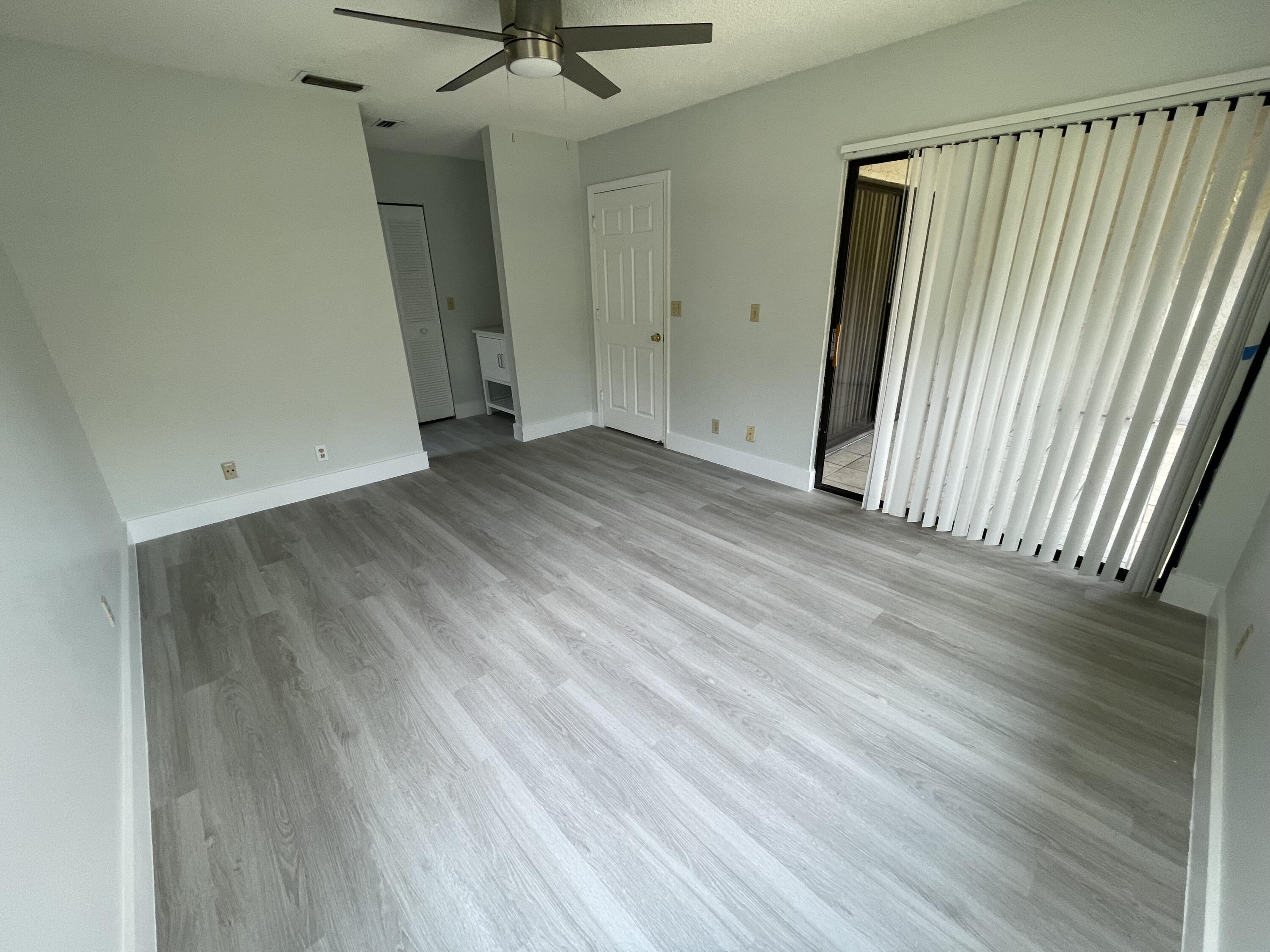 3350 Jaywood Terrace, Unit J221 Boca Raton, FL 33431 - Photo 14 of 31 an empty room with wooden floor and a window