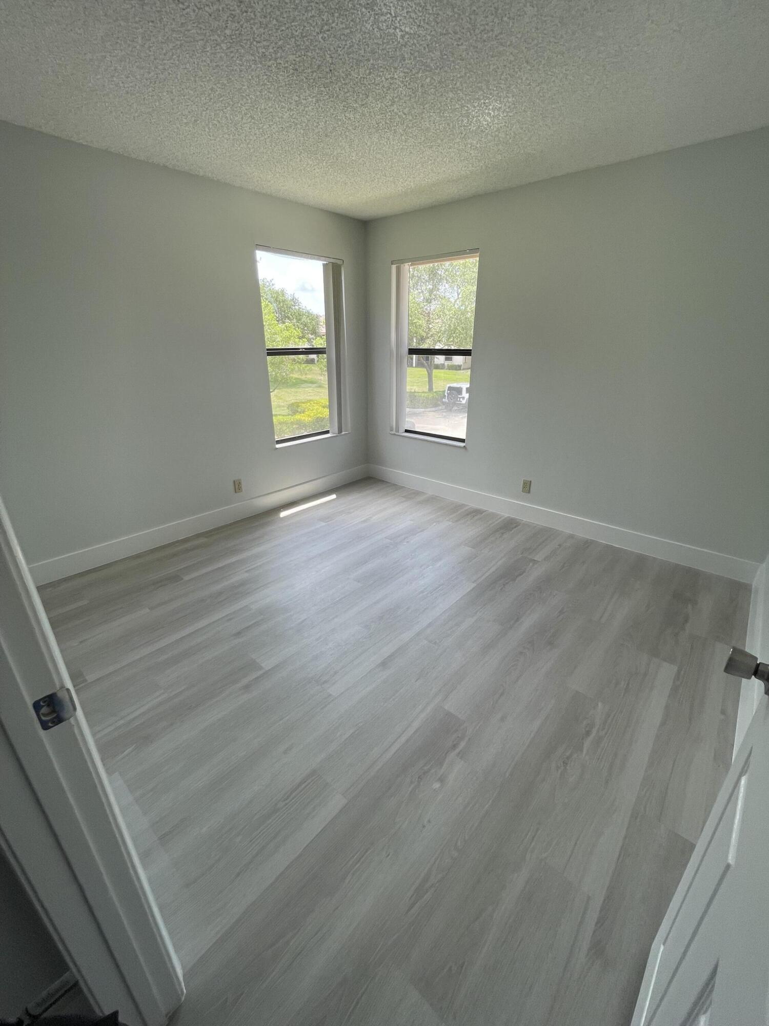 3350 Jaywood Terrace, Unit J221 Boca Raton, FL 33431 - Photo 16 of 31 an empty room with windows