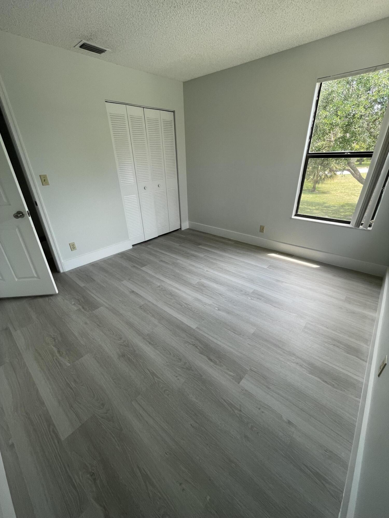 3350 Jaywood Terrace, Unit J221 Boca Raton, FL 33431 - Photo 17 of 31 an empty room with windows