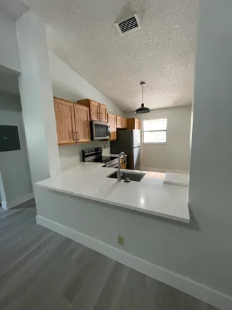 a view of kitchen with furniture and wooden floor