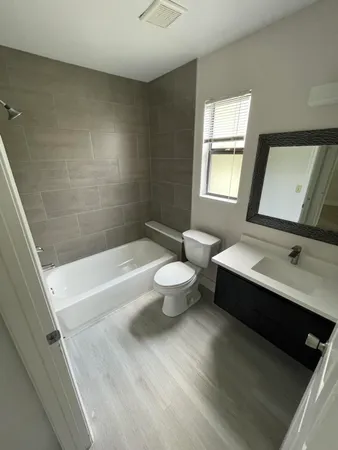 a bathroom with a sink a toilet and a bathtub