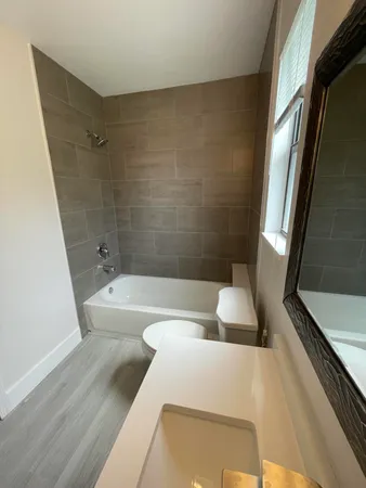 a bathroom with a sink a bathtub and a shower