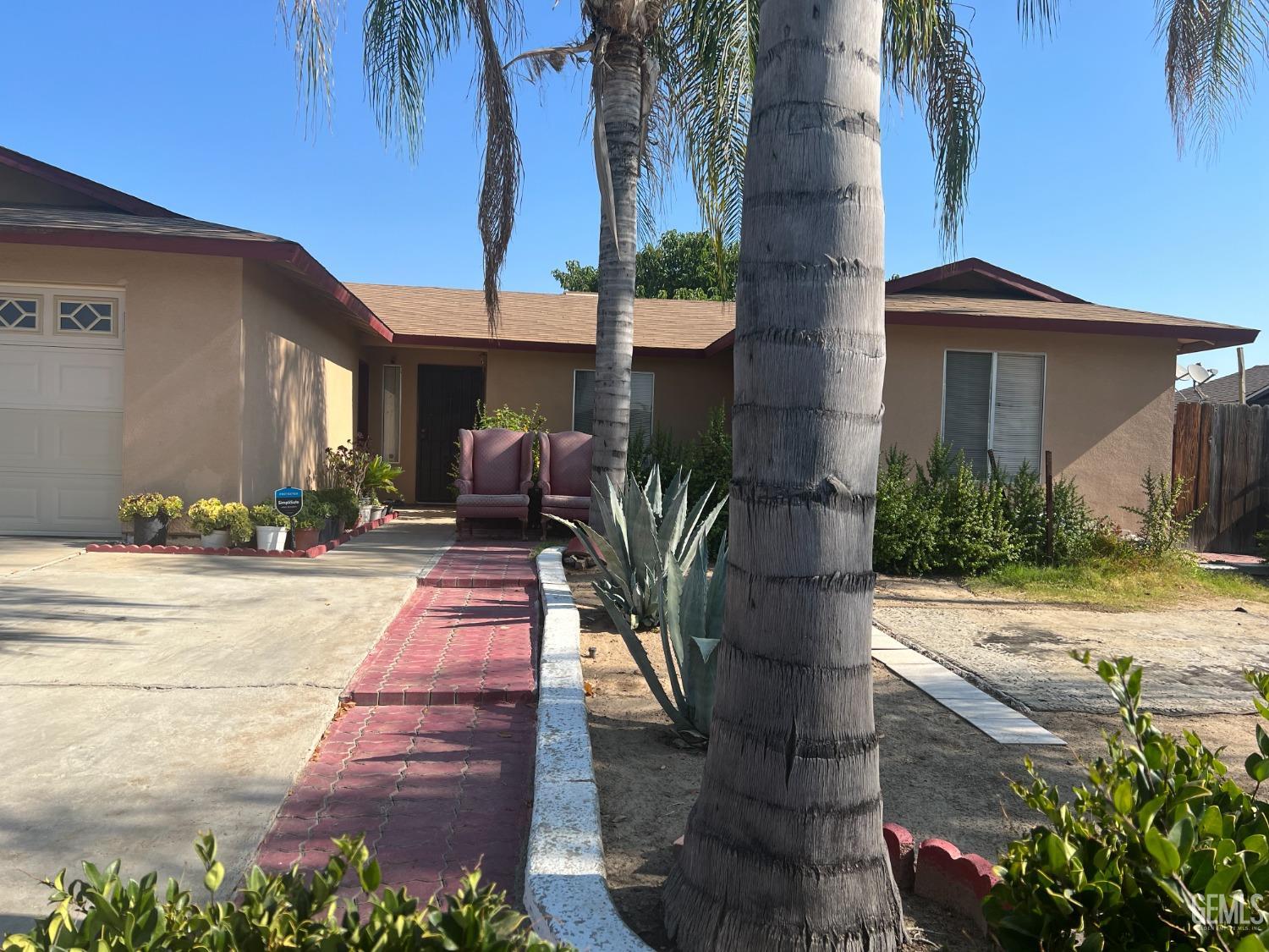 Undisclosed Address Delano, CA 93215 - Photo 2 of 9 a front view of a house with a yard