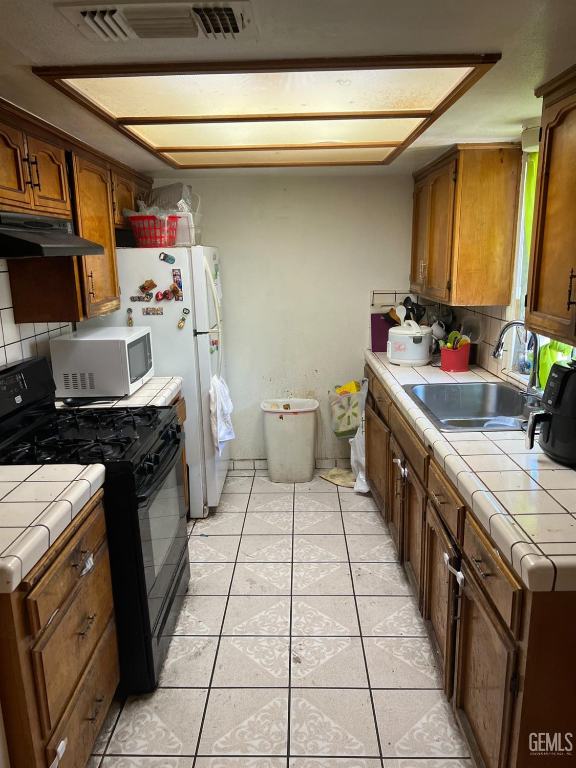 Undisclosed Address Delano, CA 93215 - Photo 4 of 9 a kitchen with a sink stove and cabinets