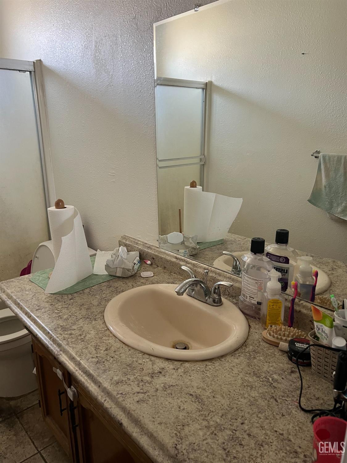 Undisclosed Address Delano, CA 93215 - Photo 6 of 9 a bathroom with a granite countertop sink and a mirror