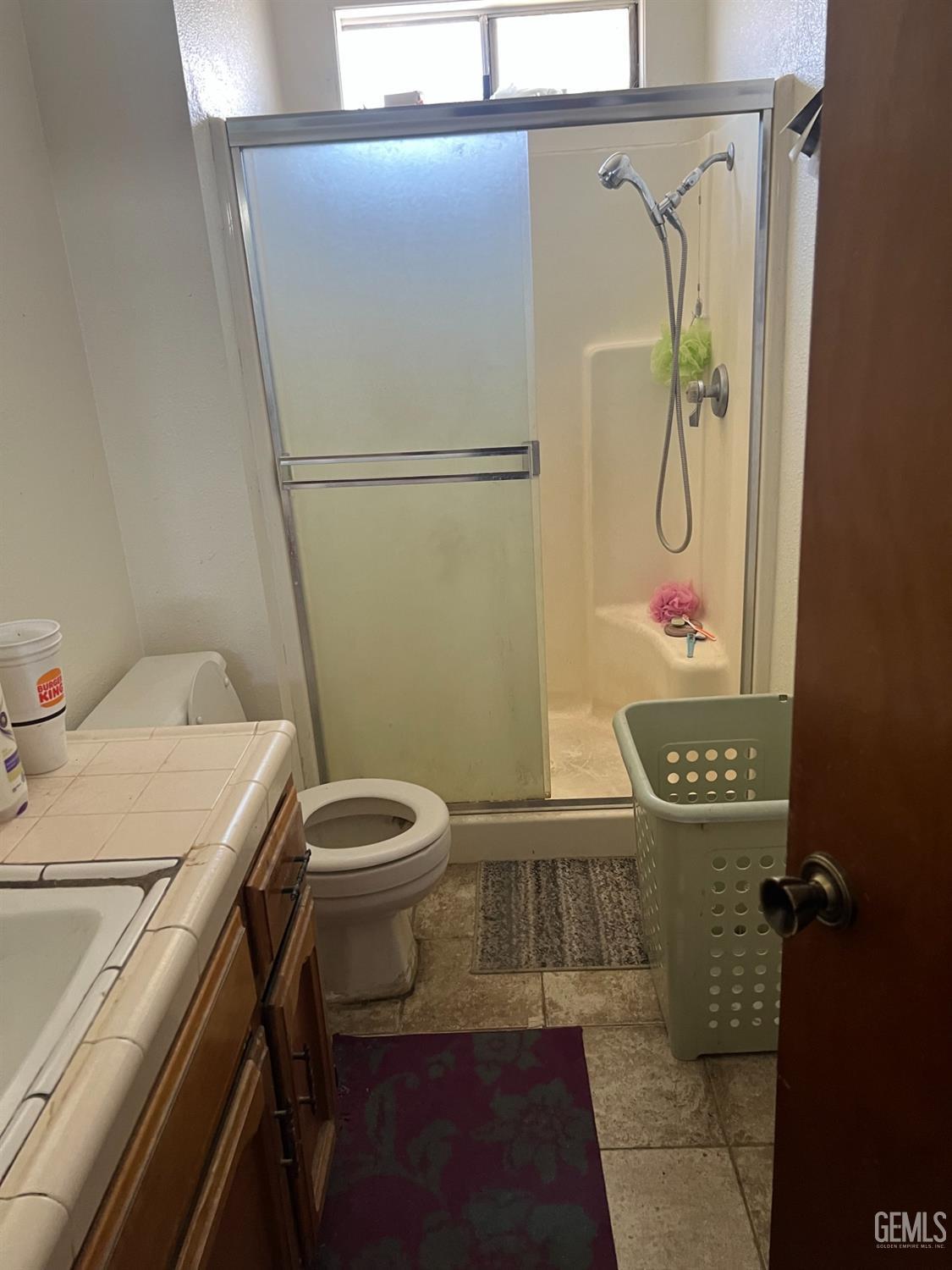 Undisclosed Address Delano, CA 93215 - Photo 7 of 9 a bathroom with a granite countertop sink a toilet and shower