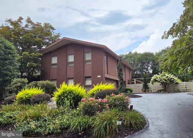 a view of a house with a flower garden