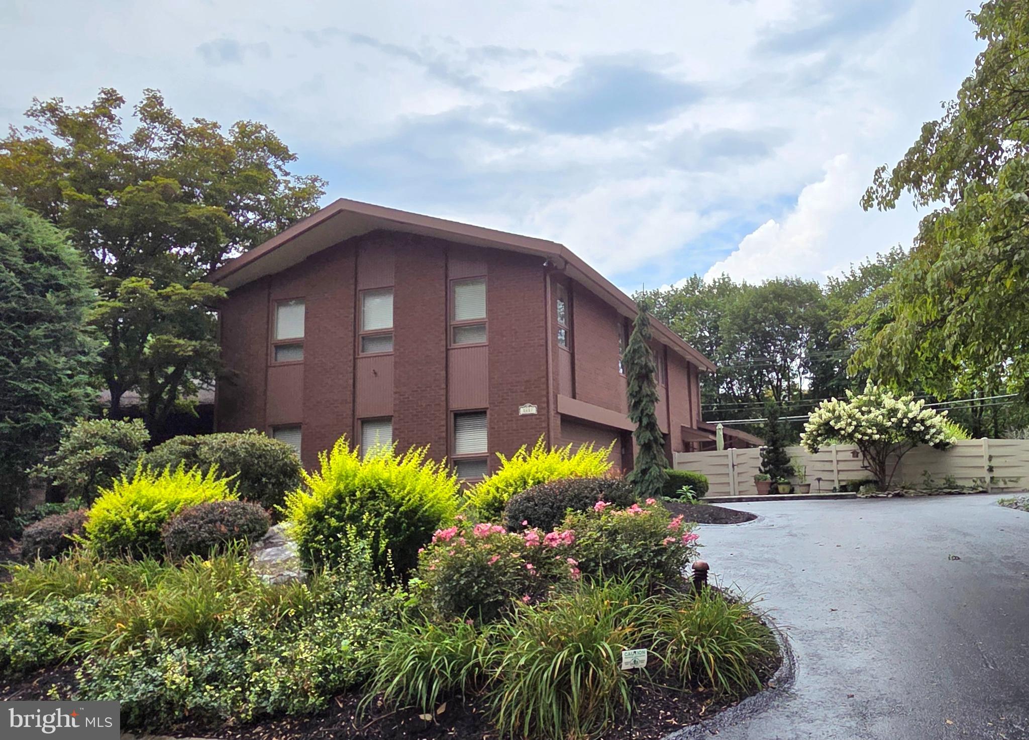 a view of a house with a flower garden