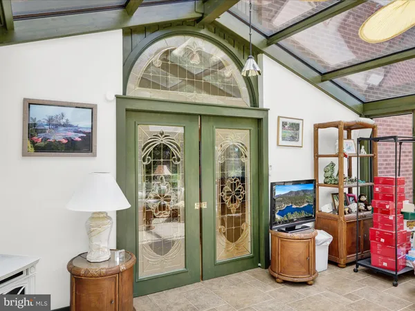 a very nice looking room with a large window and furniture