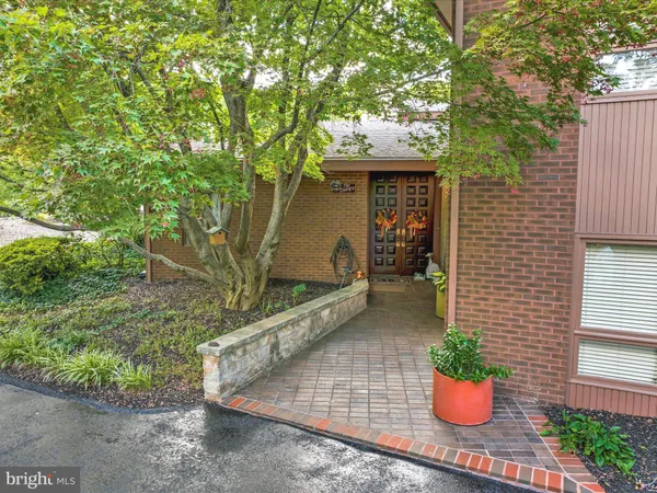 a view of a house with a yard and potted plants