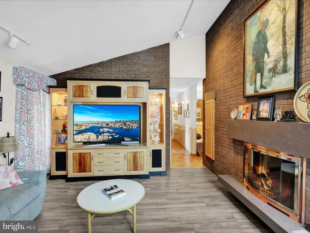 a front view of a house with a yard and potted plants