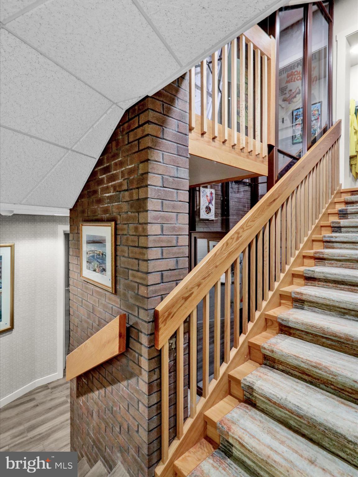 1617 Meadowlark Road Wyomissing, PA 19610 - Photo 51 of 99 a view of staircase with lots of frames on wall and a large window