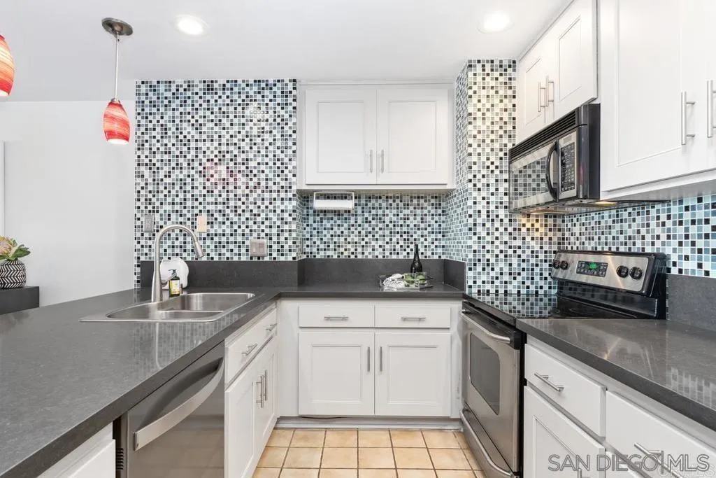 2500 Torrey Pines Road, Unit 402 La Jolla, CA 92037 - Photo 13 of 21 a kitchen with a sink a stove and cabinets